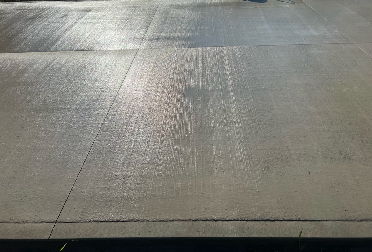 Freshly poured concrete driveway with brushed finish texture