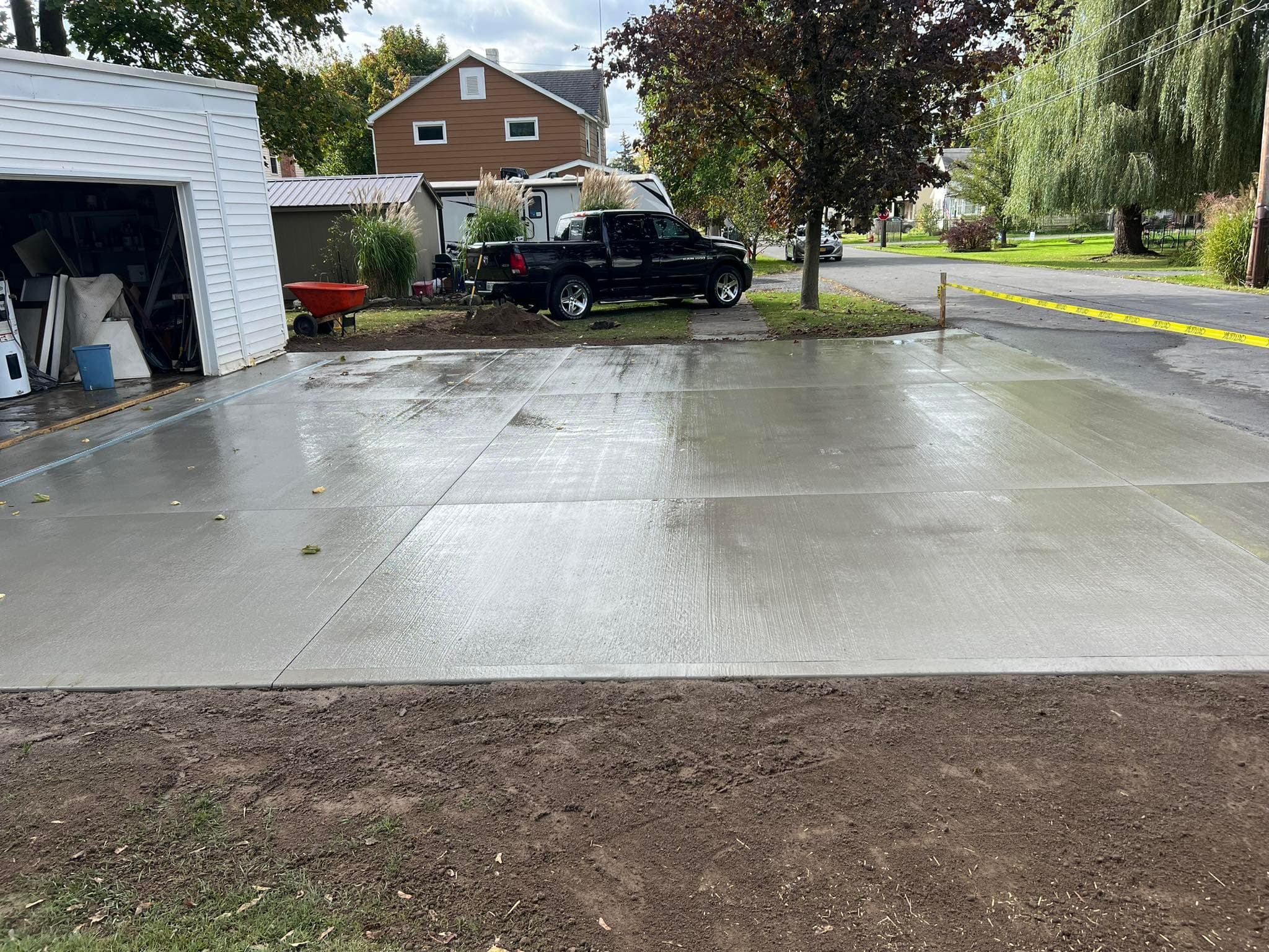 Newly poured concrete driveway with broom finish and visible texture