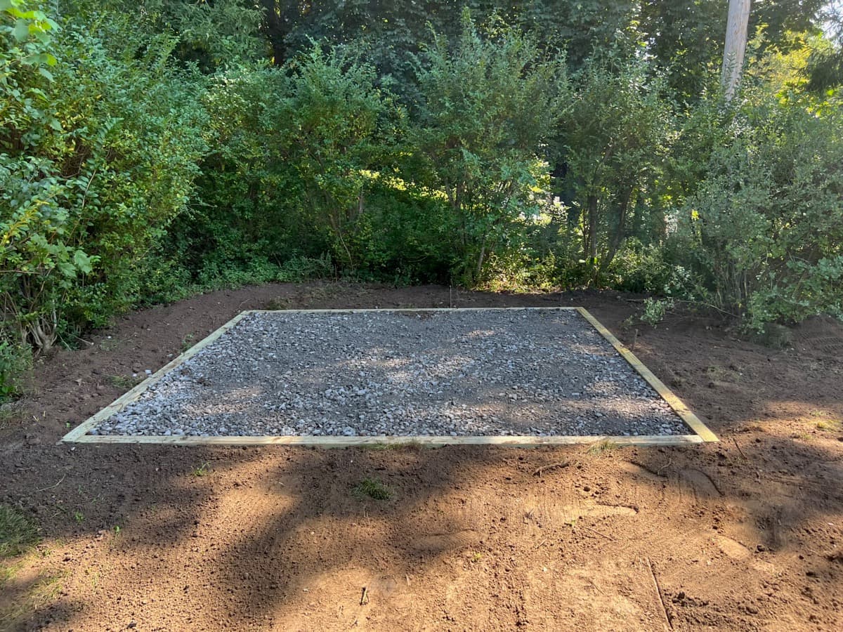 Gravel base with wooden forms prepared for concrete foundation pour