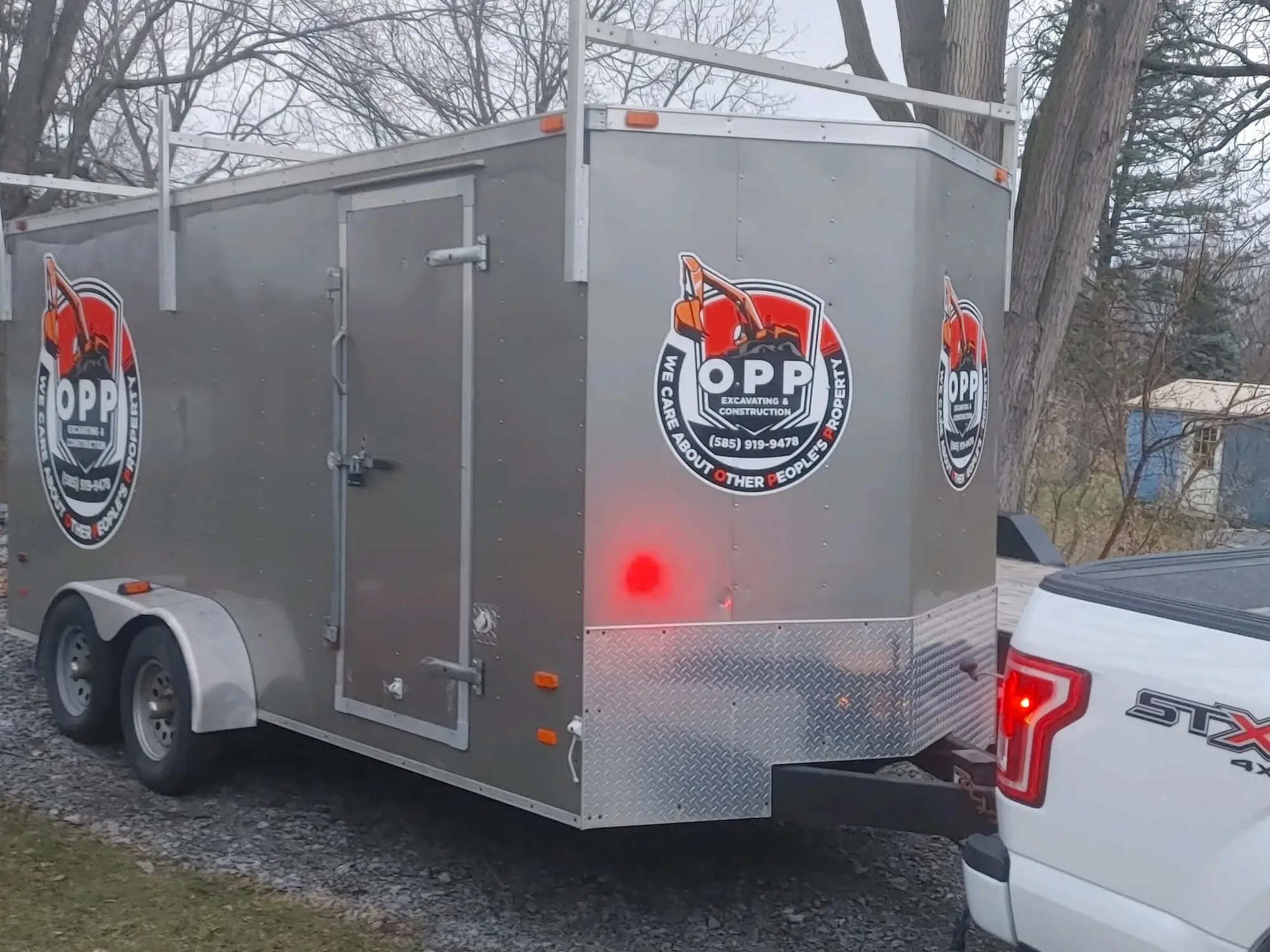 OPP Excavating & Construction branded equipment trailer